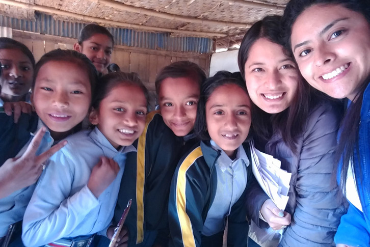 Colby-Sawyer students take a selfie with children from Nepal.
