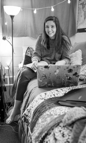 Student in her dorm room studying