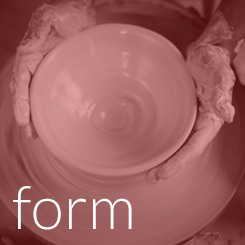 Closeup of hands forming a clay pot on a ceramics wheel