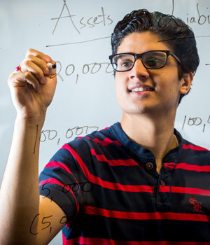 Anurup Upadhyay doing math on a glass panel