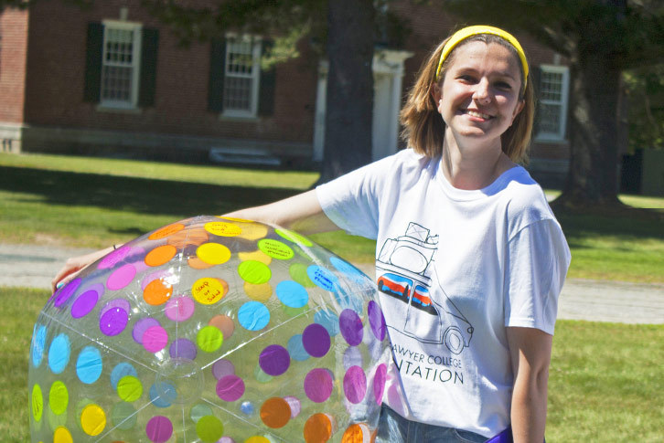 A Colby-Sawyer student holds a beach ball.